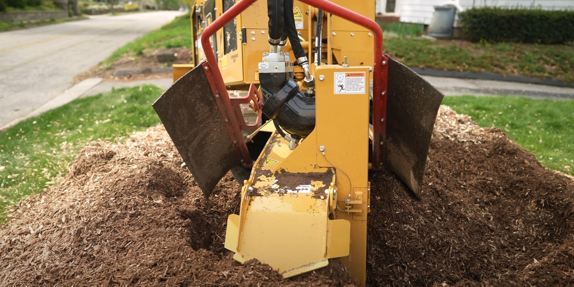 Professional stump grinding equipment in action on residential property